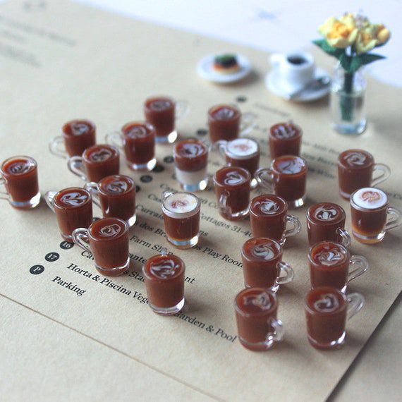 Miniature cups of coffee on a piece of paper.
