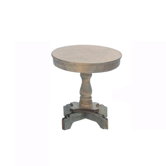 A round wooden table with a wooden base.