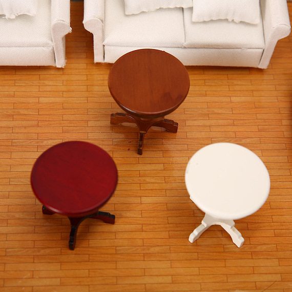 A set of four wooden tables in a living room.