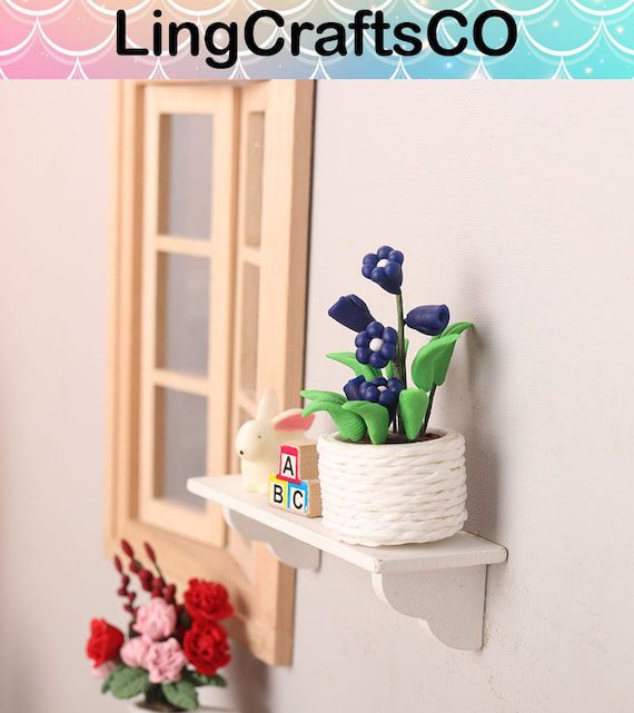 A shelf with a vase and flowers on it.